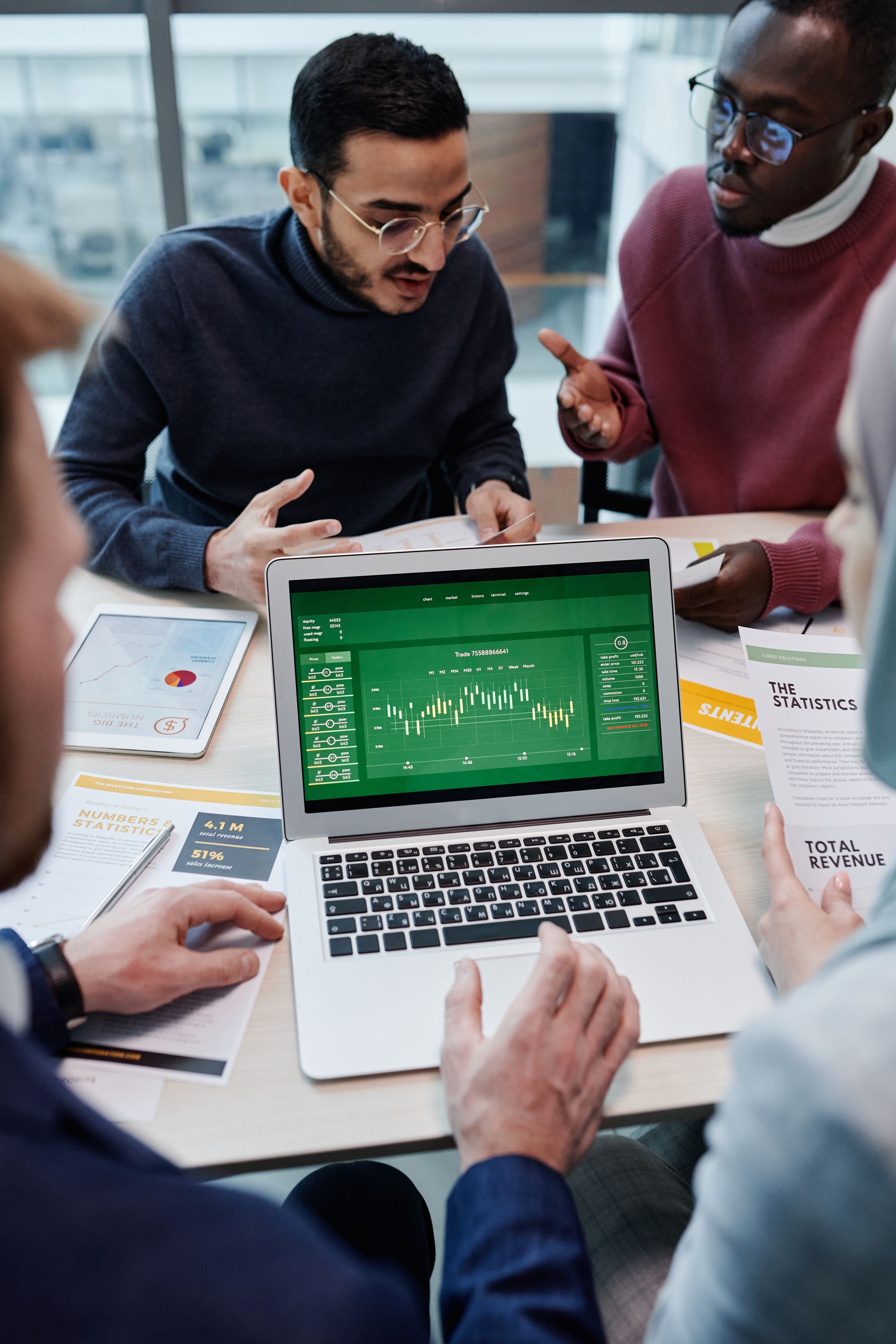 Two colleagues talking with a client across a table